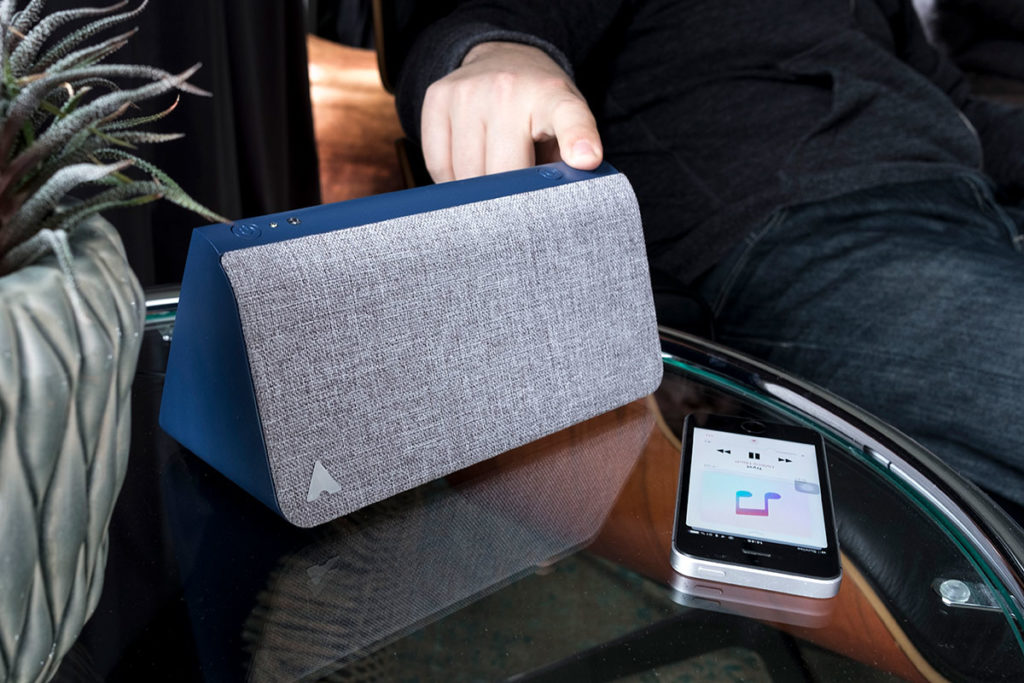 Kevin smart home device from Mitipi on a table next to a smartphone.